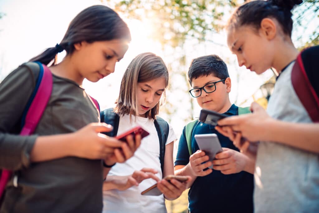 Group of kids on smart phone after school