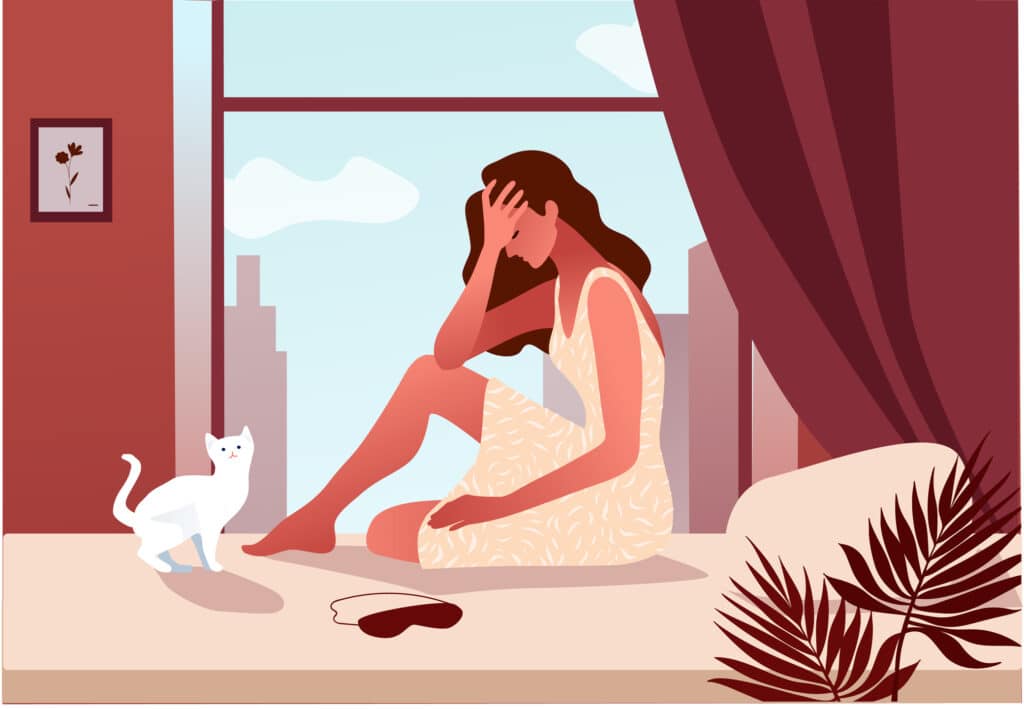 Woman in her bedroom waking up with fatigue.